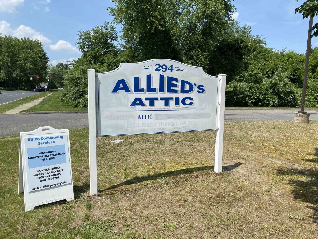 Photo of Allied's Attic post and panel sign pre-work