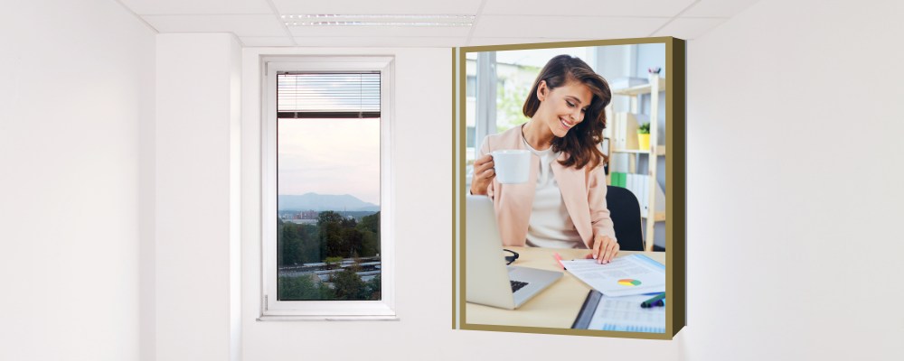 Image of an empty office with a window, and an insert image of a happy woman working at a furnished office